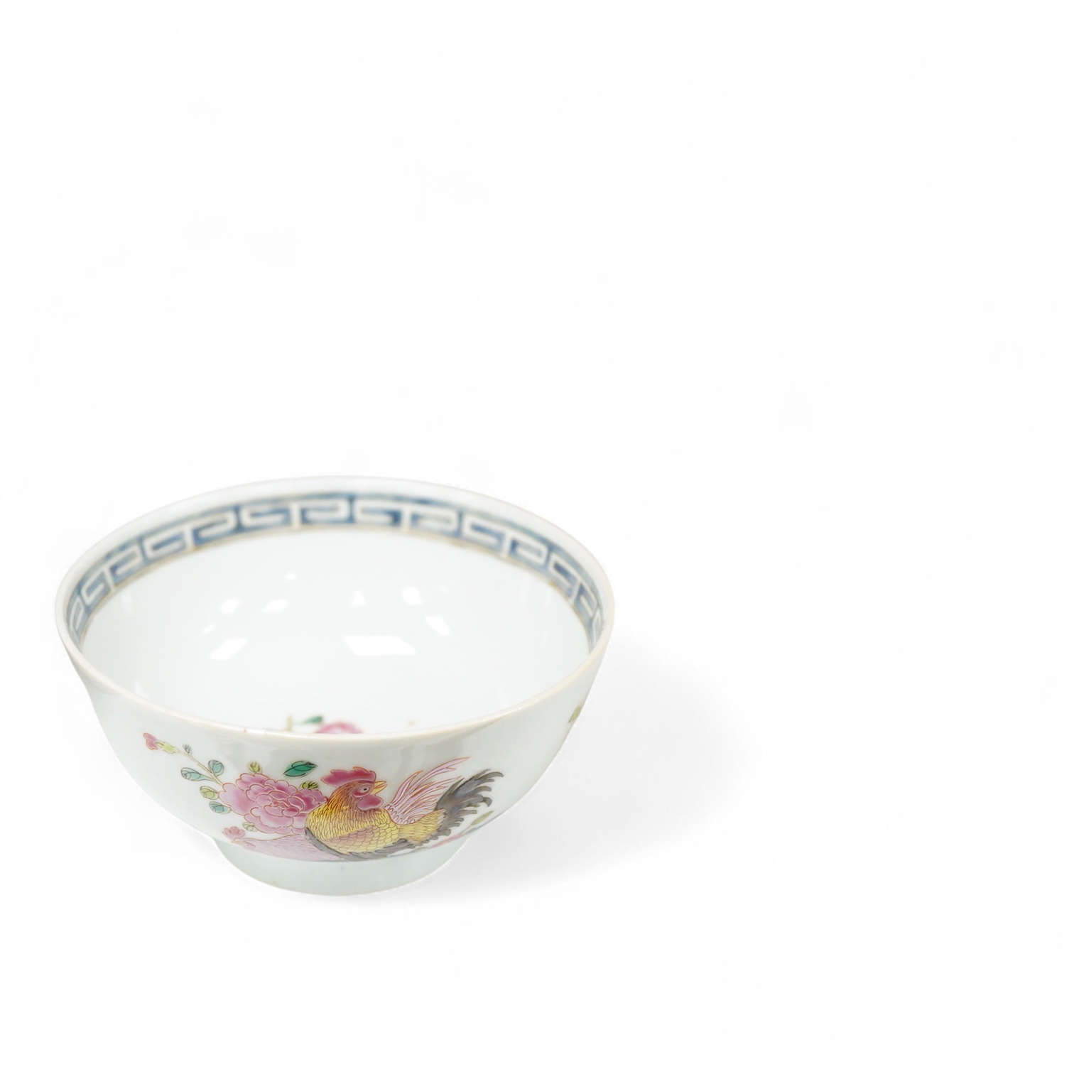 A Chinese famille rose bowl enamelled with a chicken amongst flowers, 12.5cm in diameter